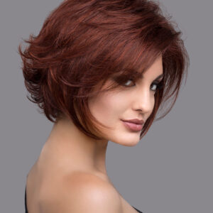 headshot of model wearing red chin length wig