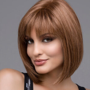 headshot of model wearing brown chin length wig with bangs