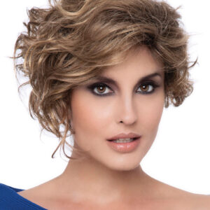 headshot of model wearing brown curly wig