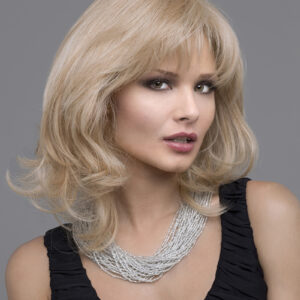 headshot of model wearing blonde shoulder length wig