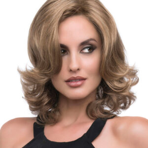 headshot of model wearing light brown wig with curls
