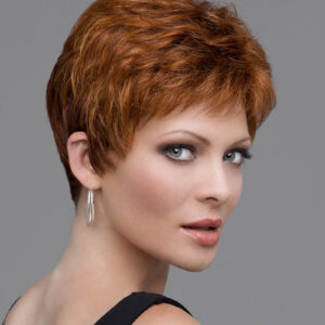 headshot of mode wearing red pixie style wig
