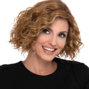 headshot of model wearing curly red wig