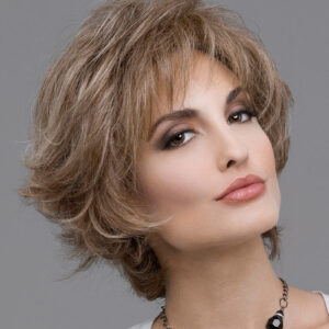 headshot of model wearing light brown spiky style wig