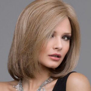 headshot of model wearing light brown bob style wig