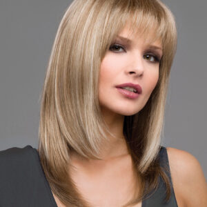 headshot of model wearing shoulder length blonde wig with bangs